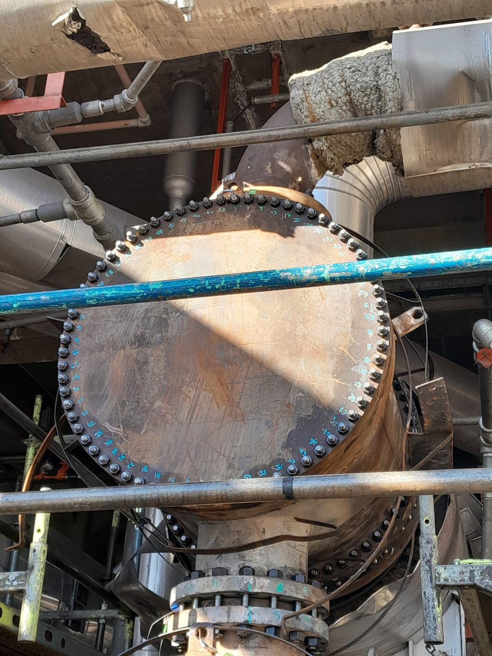 Installed multilayer closure disk bolted to a shell and tube heat exchanger during a refinery turnaround.